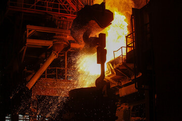 Steel production in electric furnaces. Sparks of molten steel. Electric arc furnace shop EAF. Metallurgical production, heavy industry, engineering, steelmaking