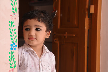 Very Cute Indian Kid Giving Pose To Camera With A Lovely Smile.