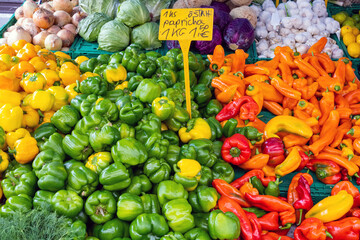 Different kinds of pepper and other vegetables for sale at a market
