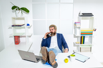 Freelancer hipster, office worker, business man finishing work before deadline, drunk ending of working day. A drunk businessman in the office.