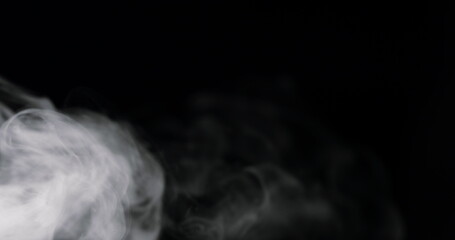 swirling white cloud of smoke against a black