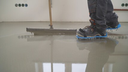 Interior of apartment under construction. Mirror smooth surface of the floor. Floor covering with...