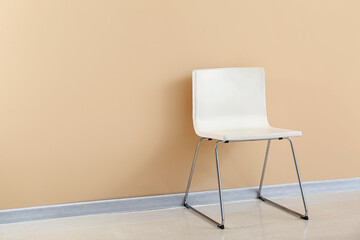 Modern chair near color wall