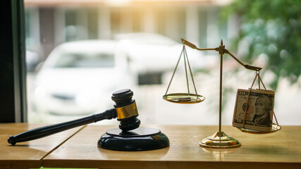 Gavel scales gold with upper dollar of justice on office desk blurred background lawyer or judge concept