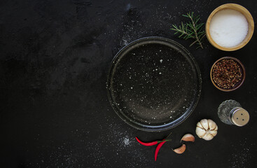 Empty black plate on a dark metal background. Top view with copy space. © Smile Studio AP