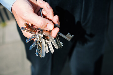 A hand holding ring with many keys.