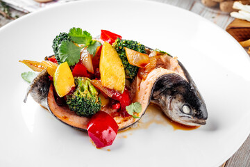 Gourmet sea bass fish filled with vegetables