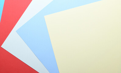 Multicolored paper background. Paper sheets of rainbow colors close-up. Geometric multitask background. Place for text. View from above.Close-up Of Multi Colored Paper.