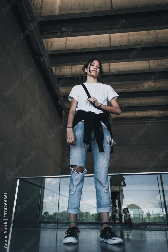 Wall mural beautiful woman Young looking forward concept of positive progress fashion city street, people advertising campaign social media, girl looking from above 