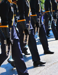 Marching band in a parade outdoors.