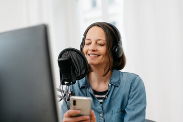Woman recording a podcast on her computer