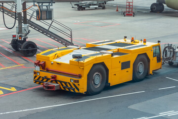 Tow truck vehicles trailer for puch back plane at the airfield. © aapsky