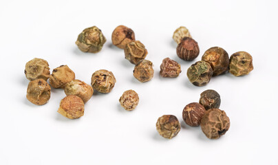 Dry green peppercorns isolated on white background board, closeup view