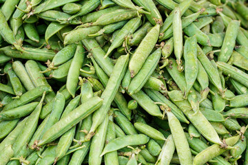 Pile of fresh green peas displayed on street food market