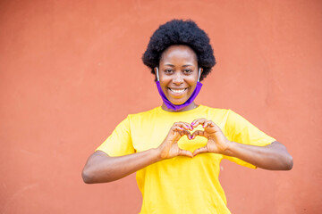young African black girl wearing face mask doing given our love, hope and believe 