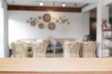 Empty wooden desk space and blurry background of cafe or Restaurant for product display montage