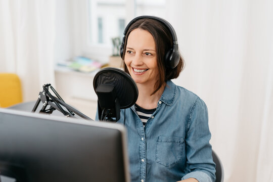 Smiling Middle-aged Woman Recording A Podcast