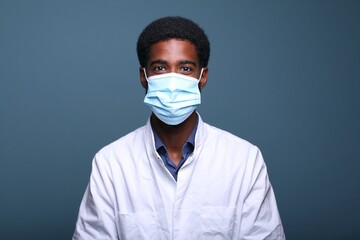 Beautiful afro doctor in front of a background