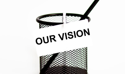 Word OUR VISION on a leaf on a glass for pencils .The concept of working in an office .
