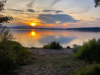 Fototapeta premium sunset at the beach boat water 