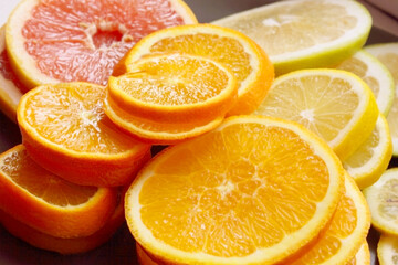 Grapefruit, Orange, lime, tangerine, lemon slices. The background is made of citrus fruits. Slices of citrus. The background of multi-colored citrus fruits. . Texture. Wallpapers. Vitamins