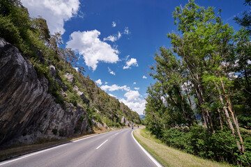 Fototapeta premium Asphalt road in Alps mountains. Trip concept.