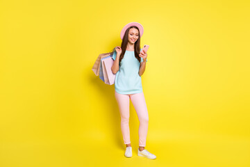 Fototapeta na wymiar Season sale shopping center notification concept full body photo girl use smartphone read news hold many bags wear pink blue t-shirt cap sunhat pants isolated bright shine color background
