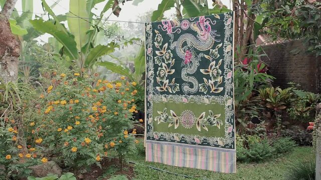 Batik fabric drying on ropes in the garden at Java Indonesia