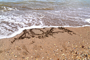 drawn numbers 2021 on the sea sand