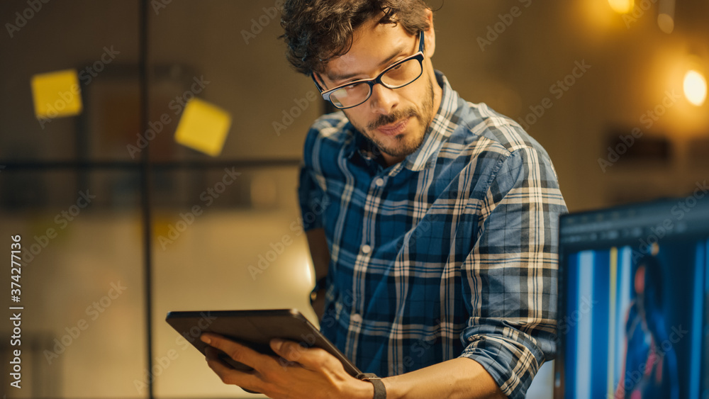 Poster shot of creative younge photo editor specialist who uses tablet computer and helping colleague with 