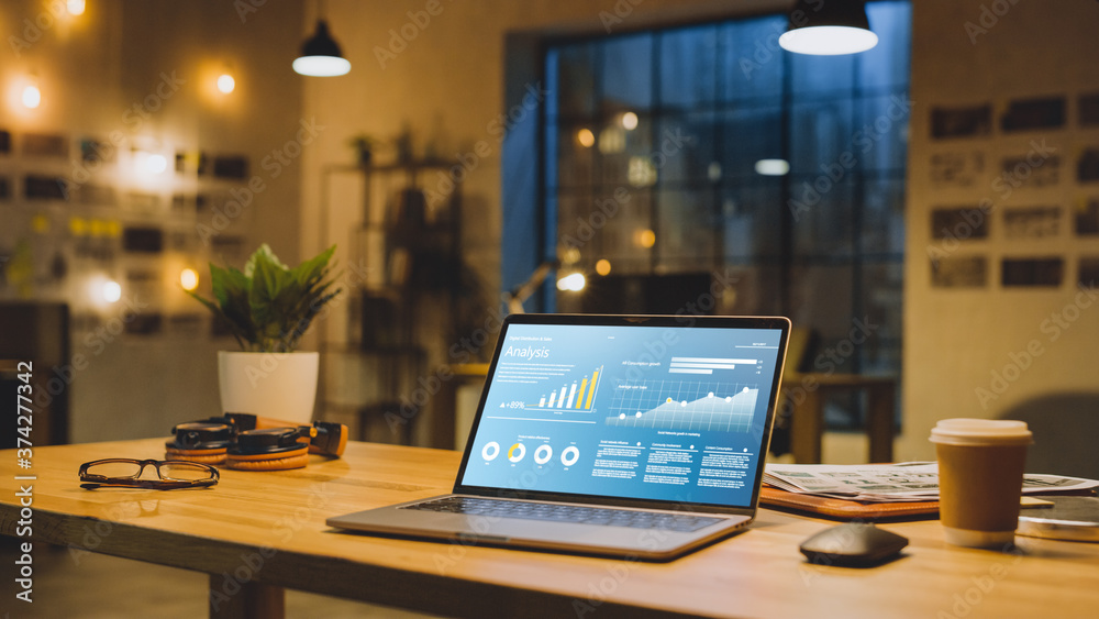 Poster laptop on the desk in the office shows company growth data with graphs, charts, software ui. in the 