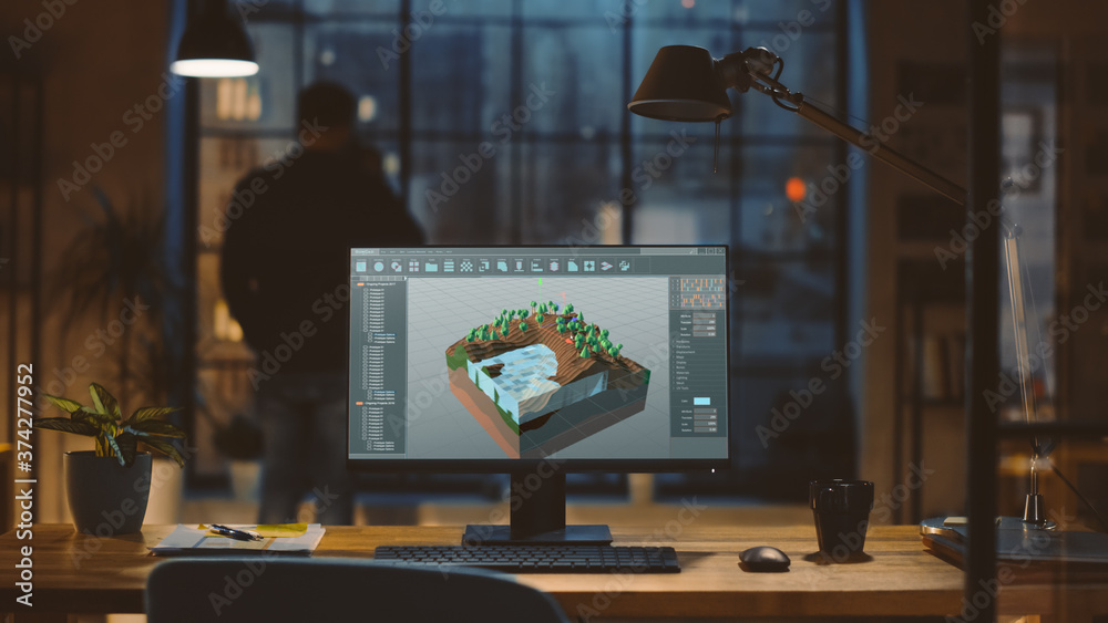 Poster Shot of a Desktop Computer with 3D Video Game Level Development Software in the Modern Office. In the Background Designer Drinks from a Cup Looks at the Night City out of the Window.
