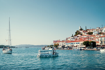 Fototapeta na wymiar Scenic view of Poros island in a typical summer day. Old town with traditional white houses near the sea. Saronic gulf, Greece, Europe.