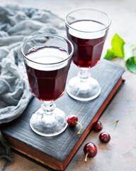 Cherry liqueur in a glass and fresh fruits