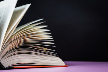 Open book on the table. It is time for education and therefore you need to go back to school.