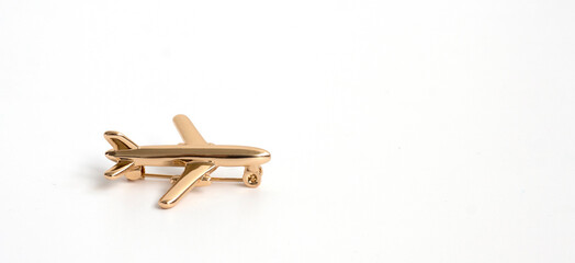 gold brooch in the shape of an airplane on a white background. Women's or men's Accessories