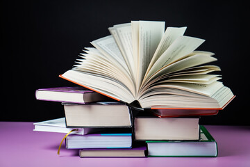 Open book on the table. It is time for education and therefore you need to go back to school.