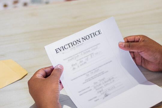 Hands of a man holds eviction notice letter