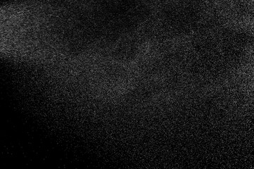 Abstract splashes of water on black background. Freeze motion of white particles. Rain, snow overlay texture.