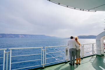 Romantic vacation. Young loving couple enjoying view on cruise ship deck. Sailing the sea.