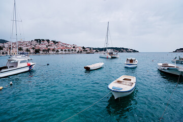 Obraz premium Fishing boats in harbor. Hvar Old Town Promenade. Sea coast in Dalmatia, Croatia.