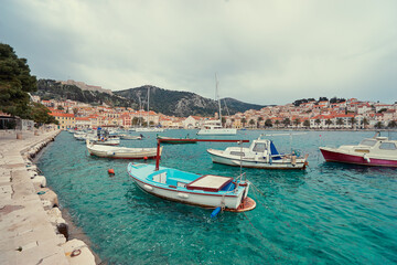 Fototapeta na wymiar Fishing boats in harbor. Hvar Old Town Promenade. Sea coast in Dalmatia, Croatia.