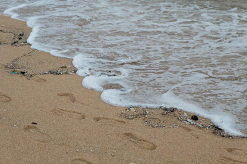 small wave on the dirty quiet beach in Thailand