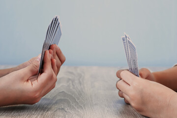 Two people competing with playing cards.  トランプを使って対決する二人