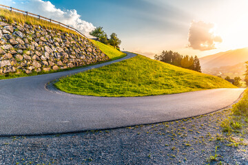Sharp hairpin curve of narrow rural asphalt road in the mountains. Austrian Alps, Austria - obrazy, fototapety, plakaty