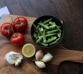 okra tomatoes onion ingredients ready to be sliced chopped for cooking