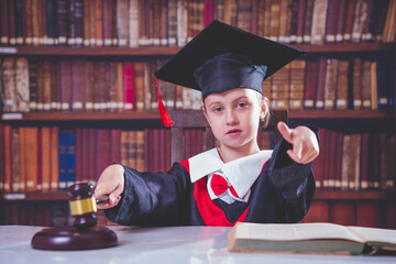Portrait of serious child girl judge (lawyer) makes a decision.  and pointing at You. Humorous...