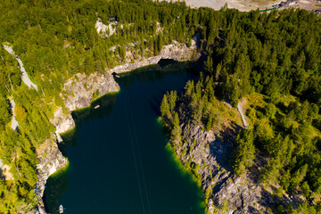 panoramic view of the green lake in the mountains in the canyon filmed from a drone