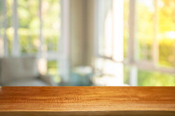 Display products on a brown wooden table in a bright white room in the morning