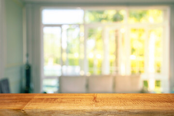 Display products on a brown wooden table in a bright white room in the morning